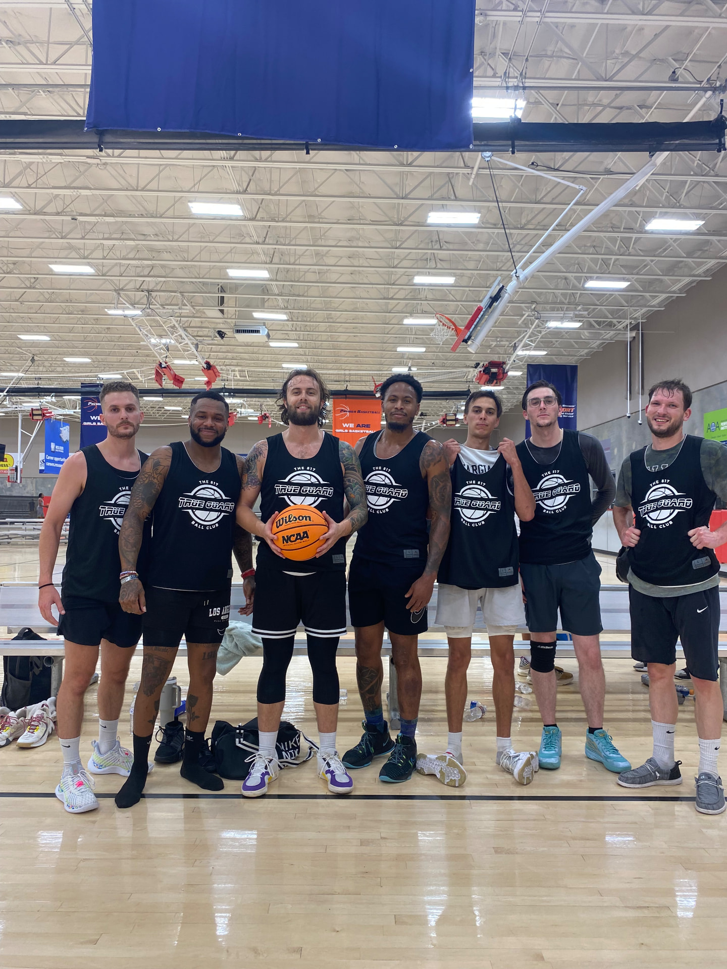 TrueGuard Basketball Team together on an indoor basketball court