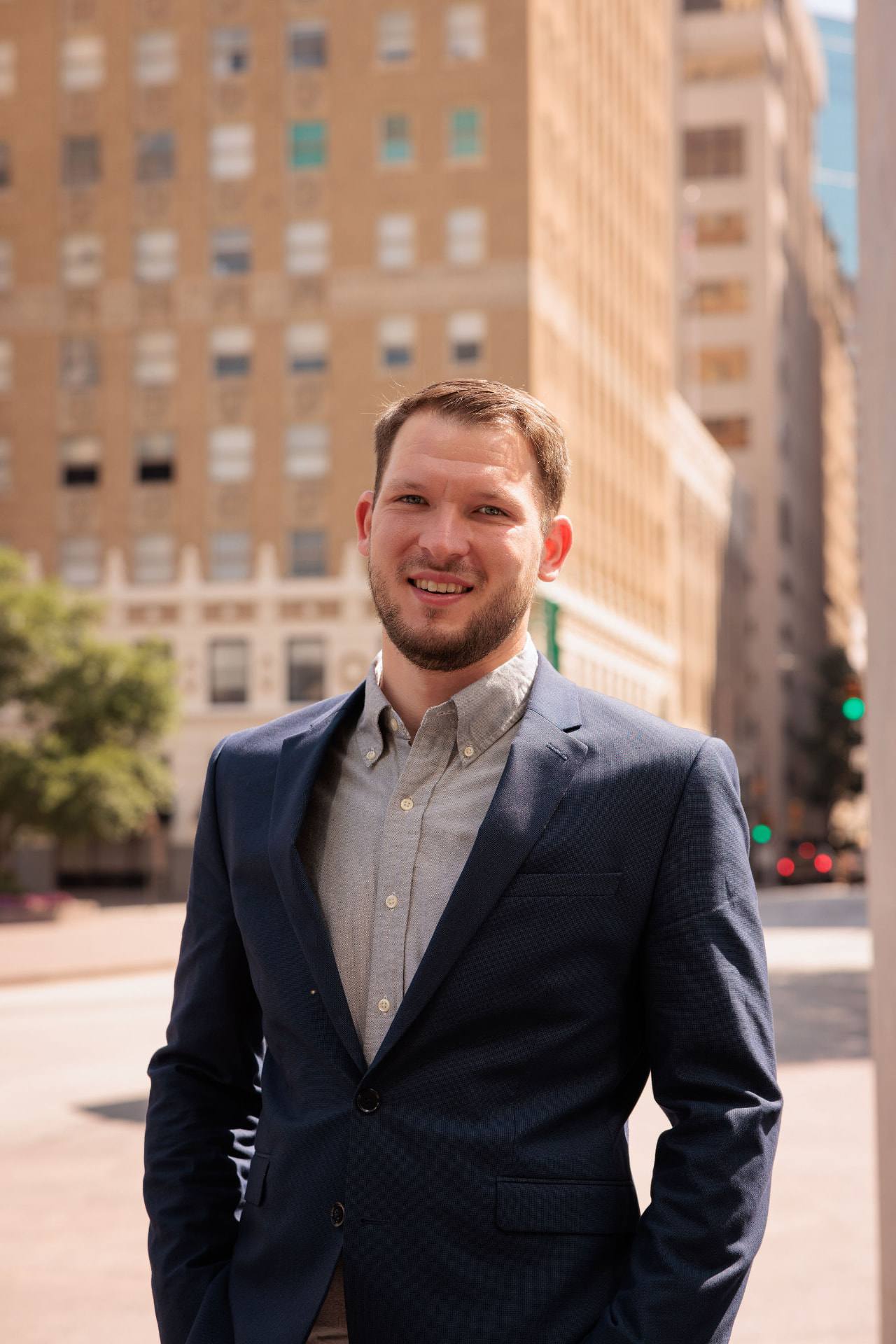 Cody Murphy wearing a navy blazer on a downtown street
