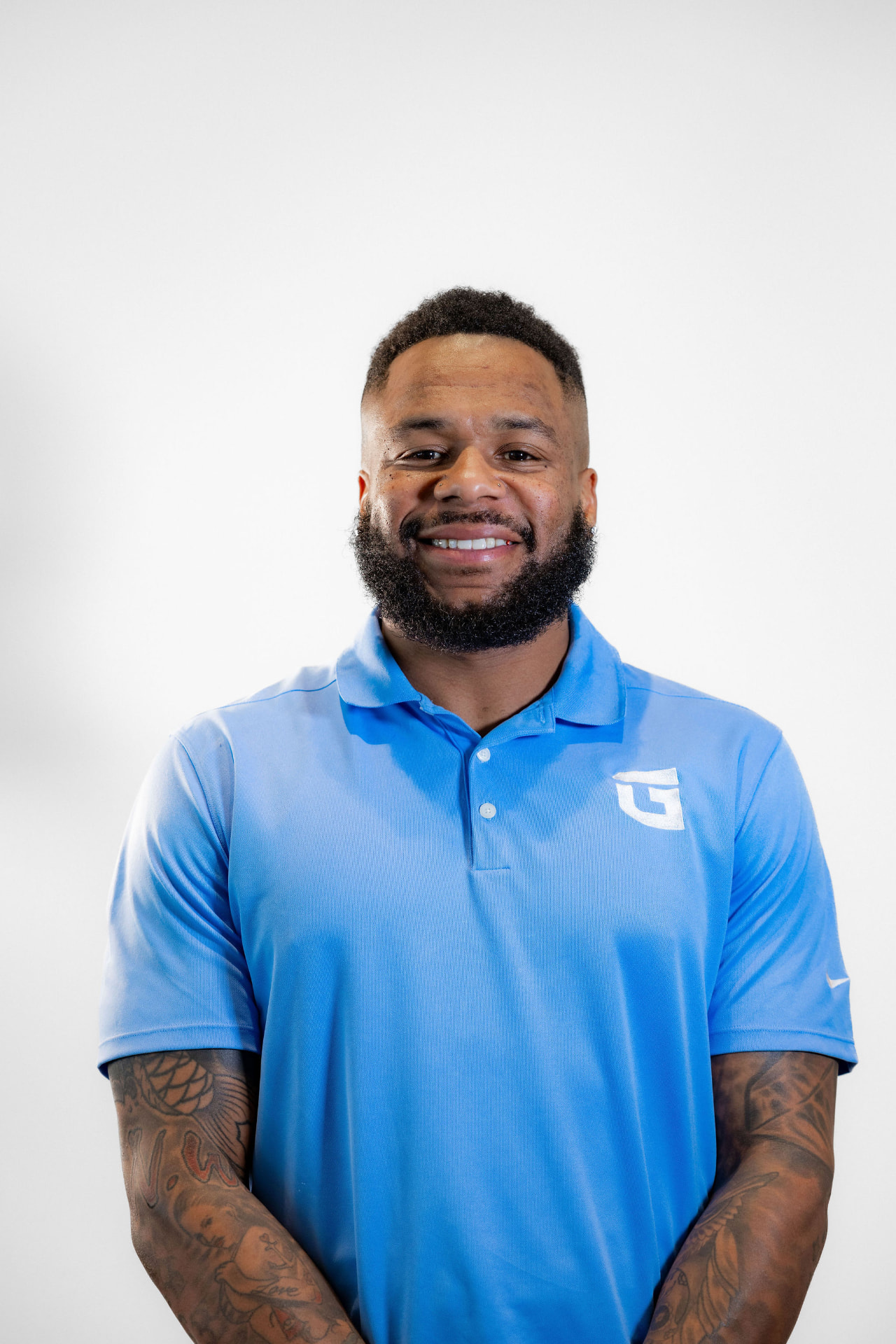 DeSean Thomas in a light blue TrueGuard polo against a plain studio backdrop